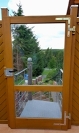Außentr aus Holz mit Glas als Windschutz